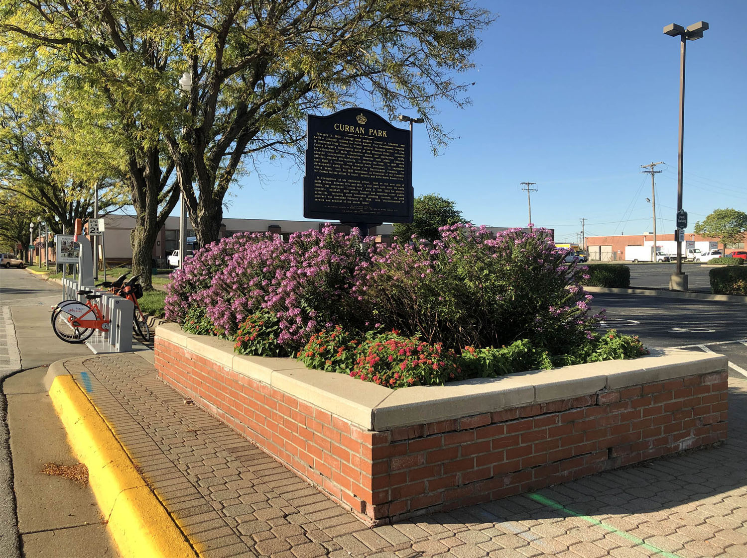 Flowerbed and sign for Curran Park.